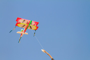 Plane kite on blue sky background