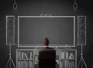 Businessman in front of a home cinema system