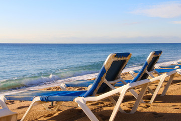 Fototapeta na wymiar Beach chairs on beach
