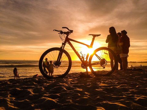 Sunset Sun Shines Through  Bike On Venice Beach In Los Angeles