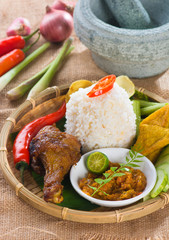 indonesian fried chicken rice on traditional background