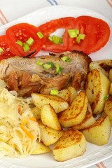 pork with roasted potatoes, tomatoes and sauerkraut