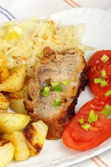 pork with roasted potatoes, tomatoes and sauerkraut