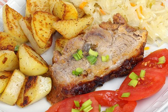 pork with roasted potatoes, tomatoes and sauerkraut