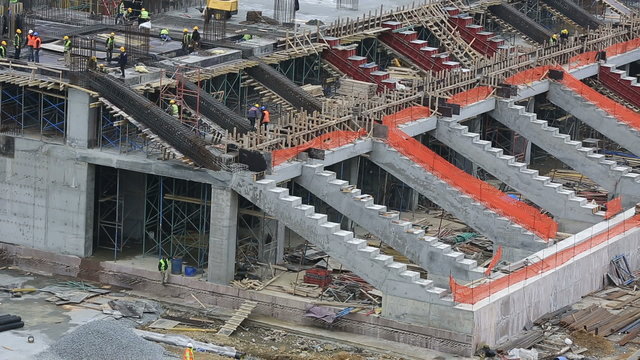 time lapse stadium construction zone with equipment and workers