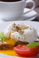Breakfast of poached eggs and coffee. vertical