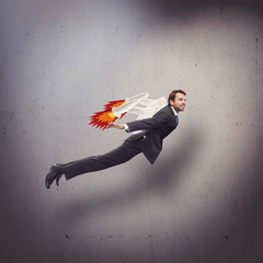 Businessman flying with rocket backpack