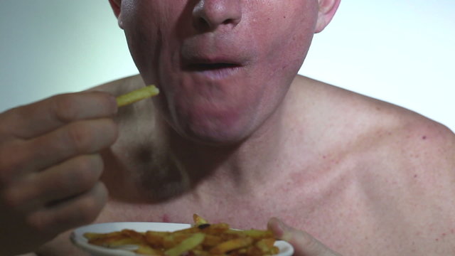 adult  man eats fried potato