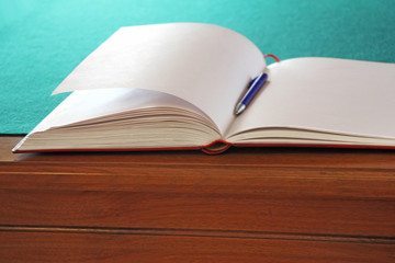 Open guestbook on the table with green cloth