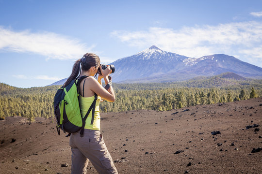 Woman nature Photographer taking pictures outdoors during hiking