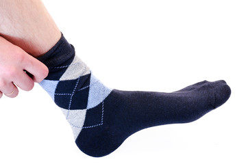 the man puts on a sock