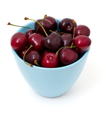 cherries in a blue cup