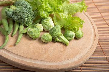 Fresh  broccoli and lettuce on  wooden board.
