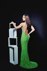 Slender woman in a cocktail dress green