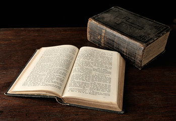 Old Bible on wooden table.