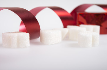 sugar cubes with red ribbon.
