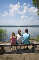 Kids sitting on the lakeside