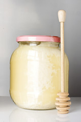 Jar of honey on the bright background