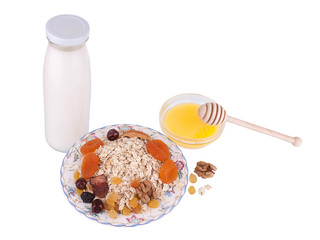 Muesli, honey and milk isolated on a white background