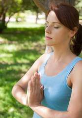 Fototapeta premium Yoga. Young woman doing yoga exercise outdoor