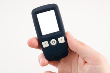 Hand holding glucometer with blank display isolated