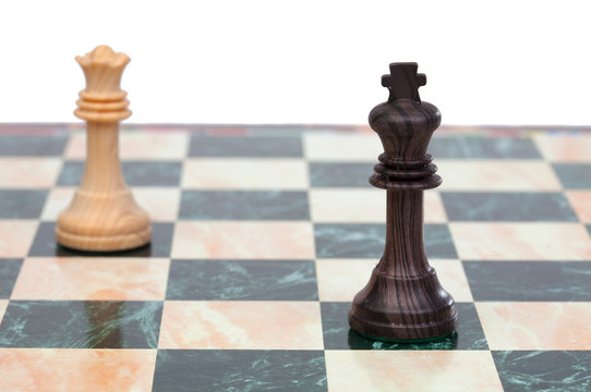 The king and queen faced. Wooden chess pieces