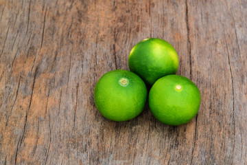 Fototapeta na wymiar fresh lime on wood background