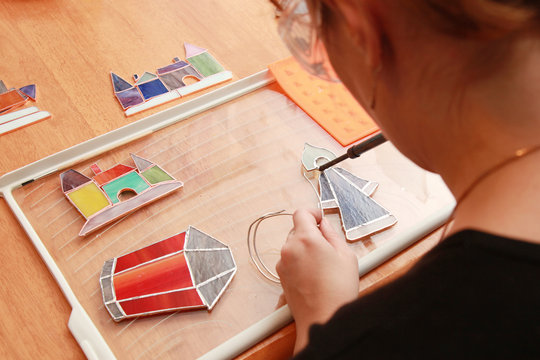 Stained glass works with small colorful souvenirs