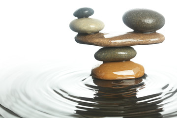 Fototapeta na wymiar Carefully balanced stones in water