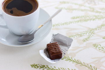 Cup of coffee and chocolate candy