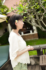 Naklejka premium Asian woman enjoying spring flowers in the garden