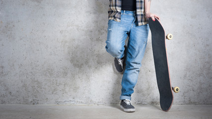 Girl with skateboard detail against concrete wall with copy spac © pio3