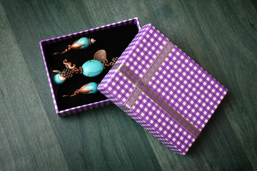 Purple gift box with green wooden background