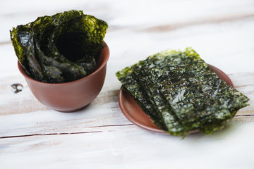 Ceramic tableware with nori sheets, close-up, studio shot