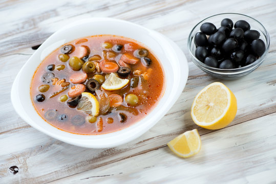 Solyanka: traditional russian soup with meat, sausage and olives