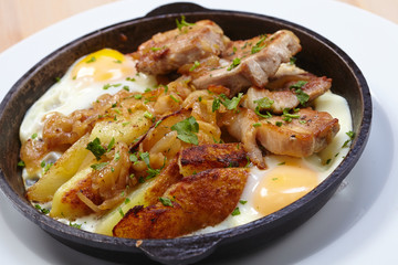 fried meat with potatoes and egg