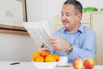 Man reading the newspaper in his spare time