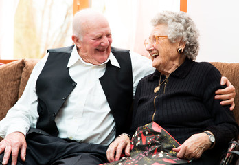 happy senior couple posing close together