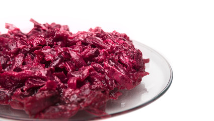 traditional Russian beet salad on glass plate , isolated