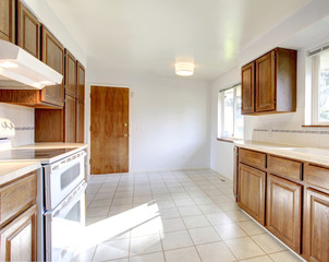 White kitchen room with brown storage combination and white appl