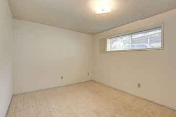 Empty small room with a narrow window