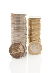 Pile of 1 and 2 Euro money coins over white background