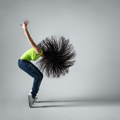 beautiful dancer girl squatting with flying hair