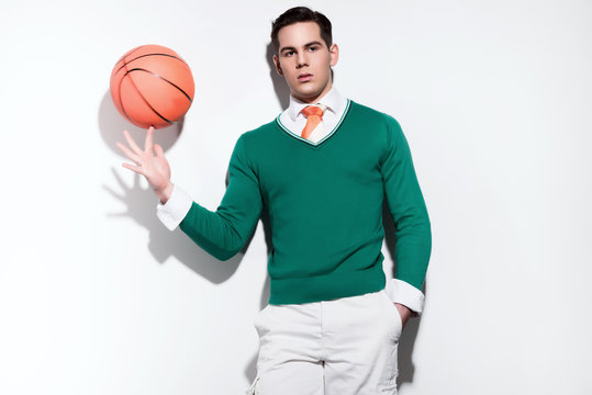 Retro basketball fashion man wearing a green sweater orange tie