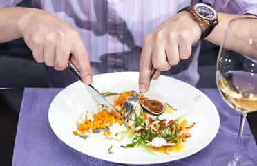 young man having dinner in a restaurant