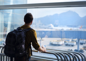 Young man at the airport is going for holiday