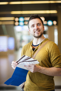 Young man at the airport is going for holiday