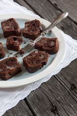 chocolate and pears cake on plate on wooden rustic table