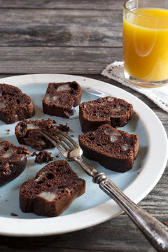 chocolate and pears cake and orange juice on wooden table