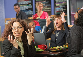 Surprised Executives in Cafe